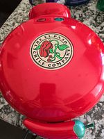 Top view showing red enamel lid with logo and indicator lights