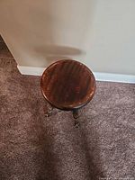 Top view of round wood piano stool seat