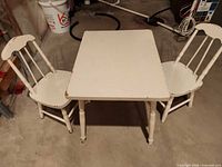 Table and two chairs full view