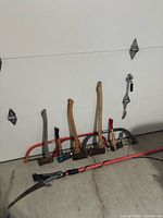 Group showing axes, bow saw frames and pole saw