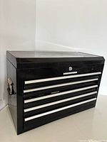 Closed black metal tool chest showing exterior condition