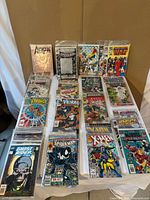 Overview of approximately 40 bagged Marvel comics on table