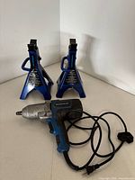 Impact wrench and two jack stands full view