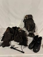 All items laid out: jacket, saddlebag, boots, pump