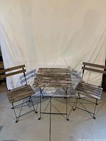Full view of folding table and two matching chairs