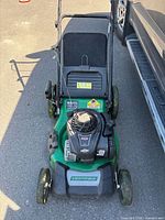 Top view of Certified lawn mower showing deck, engine and handle