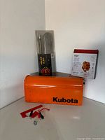 Group showing Kubota mailbox, sealed bar burner pack, boxed Chef roaster, flag and hardware