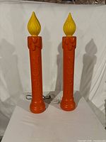 Front view of two 36" Noel blow mold candles standing upright showing cords
