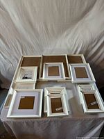Group of nine white IKEA frames arranged by size