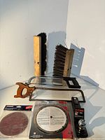 Overall lot showing hitch ball, dado blade, sanding discs, hacksaws, broom heads