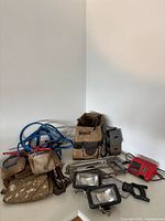 Overall lot with booster cables, tool pouches, bag, power tools, lights, charger