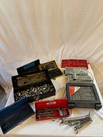Overview of all boxes, sockets and wrenches laid out on table