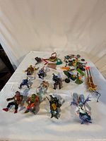 Group shot of all action figures and accessories spread on table