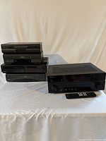 Stacked view of four VCR units and Pioneer receiver with remote