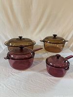 overview of four covered Visions glass cookware pieces