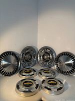 Front view of all eight hubcaps showing designs