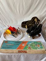 Full lot overview showing boxed Royal horseshoe set, lawn darts, roller skates and bag