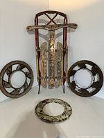 Overall lot showing sled and three cast iron rings
