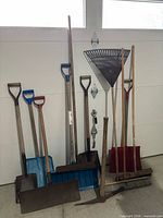 Group view of all yard tools leaning against wall