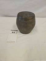 Full view of lidded jar showing dragon engraving