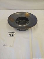 Full view of pewter bowl showing brass inlays and central recess