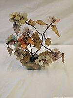 Front view of hardstone flower bonsai showing multicolored petals and stone pot
