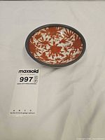Top view showing rust-orange floral design inside bowl