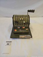 Front three-quarter view showing full Paymaster check writer on base