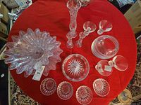 Overhead view of all pressed glass items laid out on red cloth