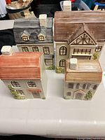 Group shot of four ceramic house containers