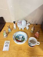 Entire lot showing figurines, stroller box, Snoopy plate and mug