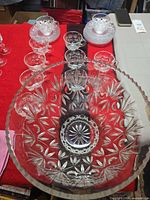 Overall view of punch bowl with several cups and stacked saucers