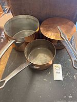 All three saucepans nested with lid on medium pan