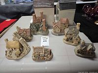 All seven ceramic cottages arranged on table