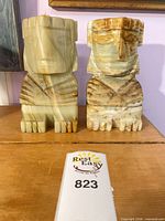 Front view of both carved onyx bookends showing color, form and condition