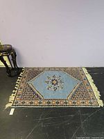 Full view of rug on floor showing overall design