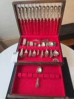 Closed chest open showing all flatware pieces arranged