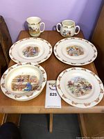 Front view showing all six pieces: three plates, shallow bowl, handled mug, two-handled cup