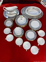 Full set showing stacks of plates, cups, saucers and gravy boat