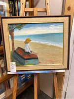 Front view of framed oil painting on easel