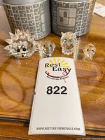 Group shot of four Swarovski crystal animal figurines and two storage cases