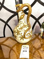 Full side view showing dragon handle, floral motif, size reference