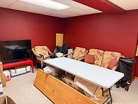 table folded open in storage room, white top visible