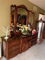 Front view showing dresser, drawers, cabinet doors and attached tri-fold mirror