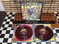 Front of gatefold jacket and both colored vinyl discs in inner sleeves