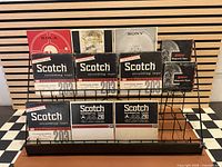 Front view of rack with Scotch, Rola-Tape, Sony and other branded reel boxes