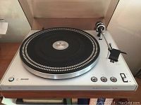 Full front view of the Philips Electronic 312 turntable showing platter, tonearm, control buttons and wood-grain front panel.