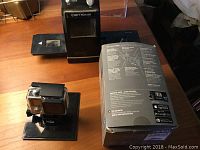 GoPro HERO4 Silver camera in protective housing mounted on a stand next to the Ion Film2SD slide to SD scanner and the GoPro accessory box.