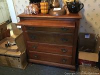 Full view of cherry finish serving stand with multiple drawers and pullout surface extended. Items on top not included.