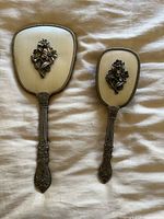 Front view of mirror and hairbrush showing decorative backs